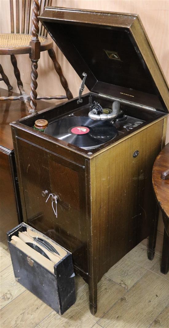 A 1920s HMV cabinet gramophone, with records and needles W.46cm